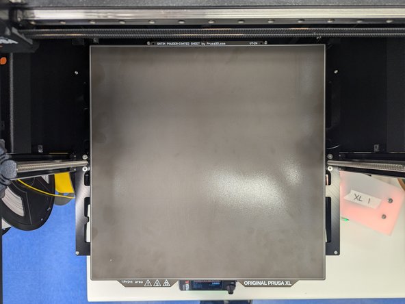 Once you have removed your print and all remaining filament from the print surface you should return the print surface to the printer.