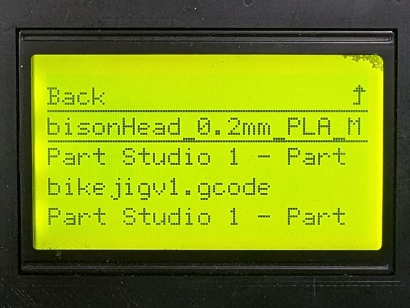 Reinsert the SD card into the printer interface (the SD card label should face away from you). Your print file should appear at the top of a list of files. If not you may need to scroll through a list of files.  Locate your file by name, rotate the knob to highlight your file, then press the knob to select your file.
