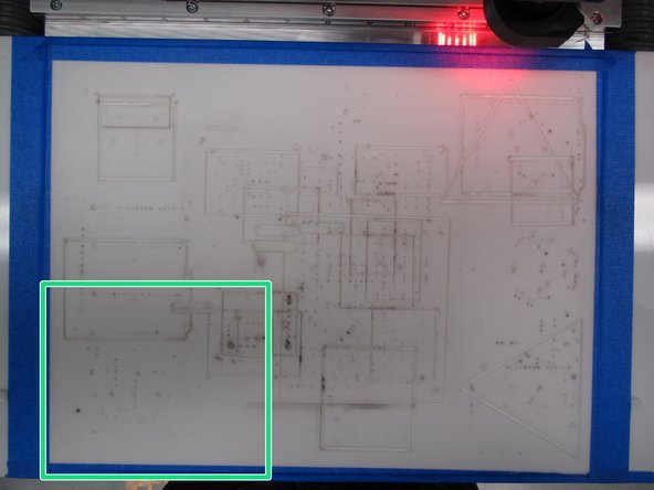 Place the jig within the bounds of the blue tape around the edges of the mill bed, then place your copper clad inside the jig.