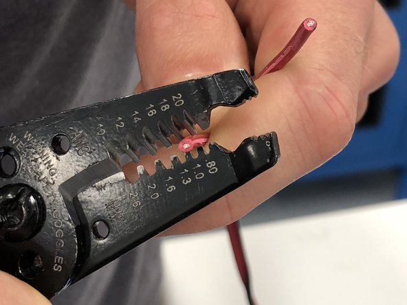 Using your fingers or a pair of wire cutters, separate the red and black wires about three inches.