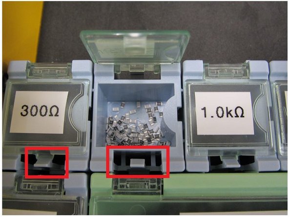 The lid to each bin is spring loaded.  Gently pull back on the clip of each bin to open the corresponding lid.