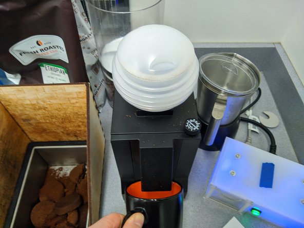 Place the white plastic bellows completely over the gray plastic chute of the grinder.