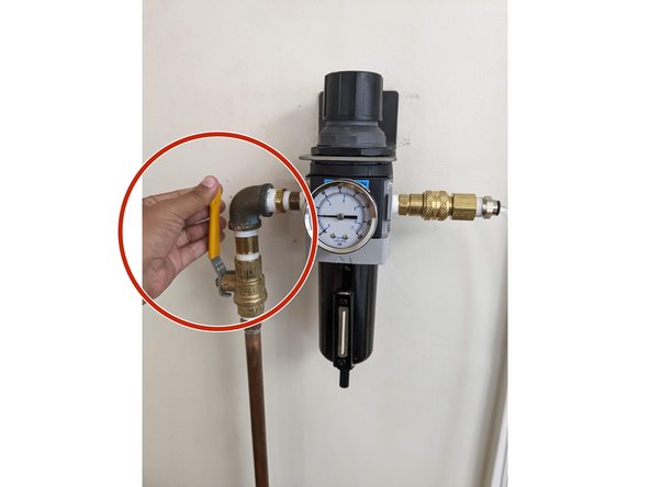 First, turn the yellow handlebar on the wall located to the left of the laser cutter from a horizontal to a vertical position. You will hear a hissing sound. This is allowing air to flow freely into the laser cutter to prevent fires.