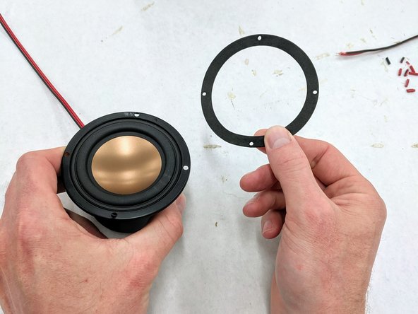 (8)Remove one of the speakers from  the white cardboard box and locate the included rubber gasket.