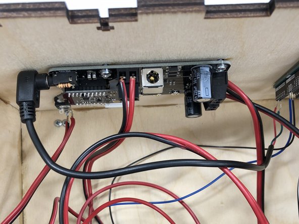 Secure the two audio wires to the Arduino terminals with a small drop of glue from the glue gun (use a popsicle stick to apply).  Otherwise, these slip out easily.