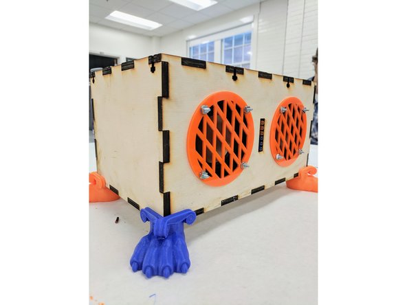 (33) Find the 12V DC power supply in your bag and connect it to your speaker box via the barrel jack in the back panel.  Plug the other end into a wall receptacle.