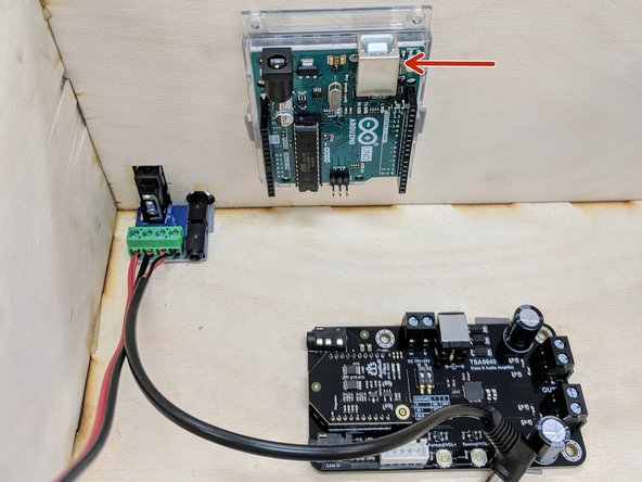 Remove the white strip from the VHB tape and adhere the Arduino inside the box on the back panel as shown here. Orient the board so the USB port is pointing up, so it can easily be connected to and programmed.