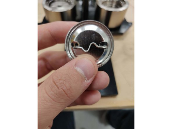 Make sure that the spring side of the pinback is on the right side and the kinked side of the pinback is facing upward.