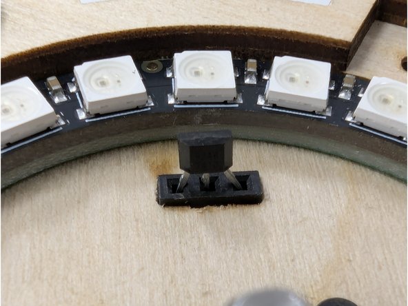 It may also be helpful to use a pair of tweezers to gently place the sensor into the slot and align the leads.  Do not use tweezers to push down on the sensor!  Use a stronger tool for applying pressure.