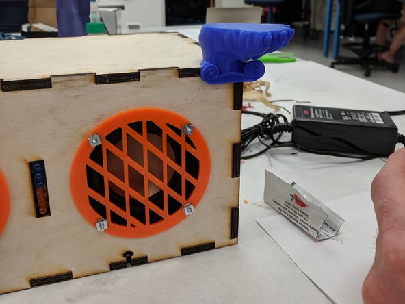 Using the popsicle stick, apply some of the epoxy to the mounting point of one of the feet.