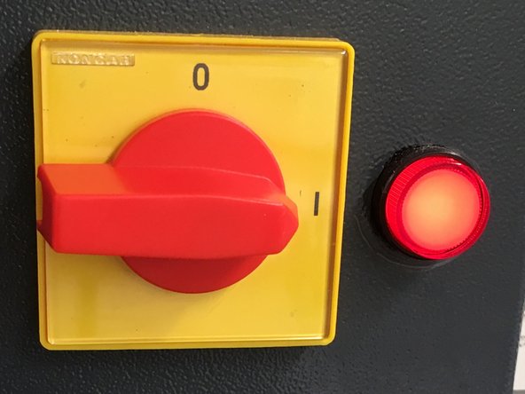 The load frame motor is powered on using the rotary switch on the load frame itself. The motor must be on for the crosshead to be moved.