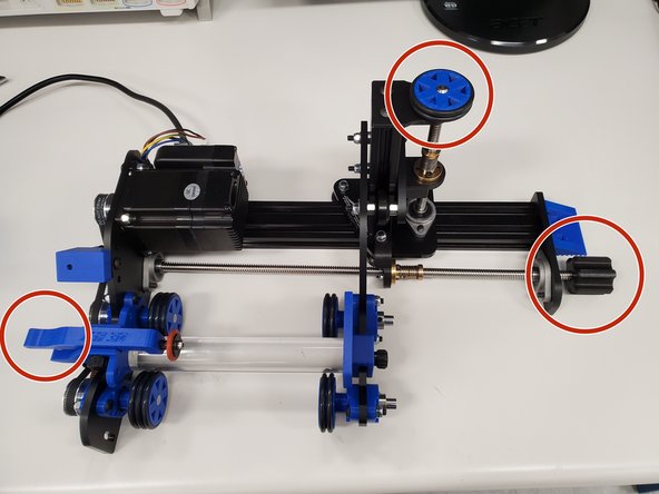 Use the screw on the right to adjust the length of the RotoBoss to the length of your material. Place your material on the wheels of the chuck and use the handle on the left to clamp it down into place.