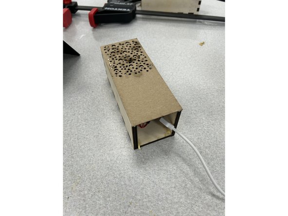 Carefully glue the lid onto the box. The end with the Neopixel should be opposite the open end of the box.