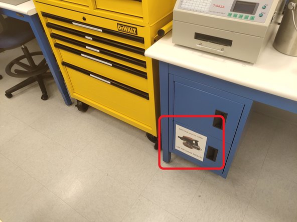 Lift the lid of the mill and remove any copper clad material or orange plastic shim stock.  Set this material aside.  The white bed should be completely empty.  Do not remove the blue tape around the perimeter of the bed.