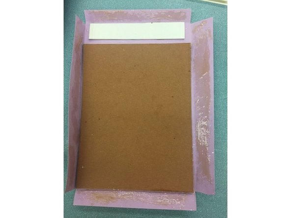 Lightly coat the edges of the front paper and glue it down.