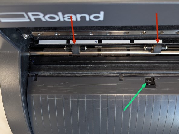 Load your vinyl square into the vinyl cutter.  The square should sit between two of the white alignment marks on the left of the vinyl cutter.  The vinyl square also needs to cover the optical sensor (called out with an arrow in the second image).