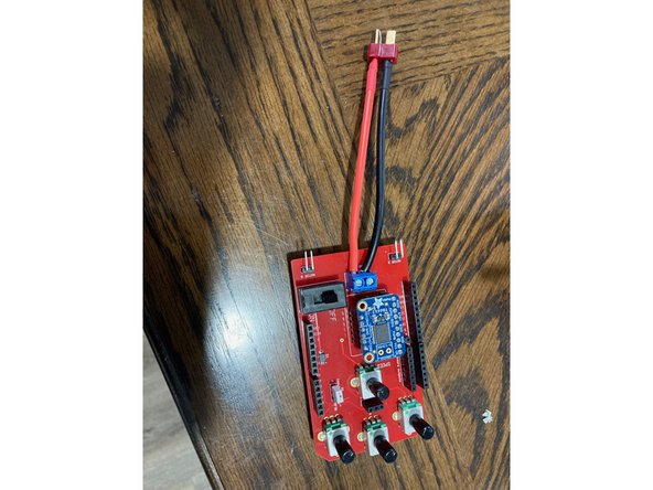 If your Arduino does not already have them, stick the rubber bumpers to the bottom to protect it from shorting or scratching the grate.