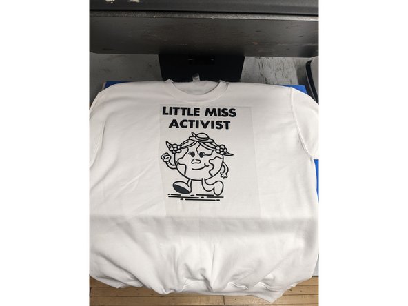 As you are finishing peeling your vinyl, turn on the heat press located next to the vinyl cutter computer. (If you are printing on something other than an apparel item, see a staff member for assistance).