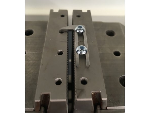 Tension test specimens must be secured in the upper (traveling) grip before the bottom (fixed) grip in order to prevent excessive preloading of the sample.
