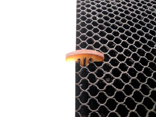 If your material is slightly warped and will not lay flat on the bed you may use T pins to help flatten it.  The pins are located in a blue dish to the left of the Glowforge.