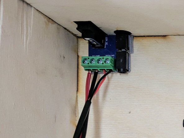 (11)Remove the white backing material (the &quot;3M&quot; side) from the VHB tape and adhere the PCB to the bottom left corner in the rear of the box.  Be sure to align the barrel jack/rocker switch and audio jack with the cutouts in the rear of the box.