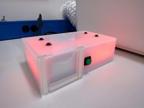 Slide your card into the box and wait for the laser cutter to turn on. The lights inside the cutter should all light up.