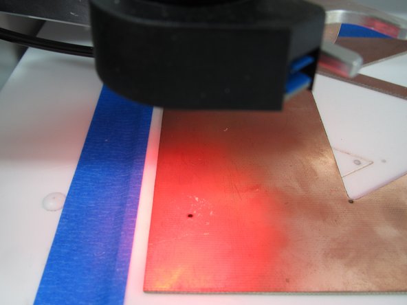 After two minutes have elapsed the mill will drill a 1.5mm hole, move the camera head to view the drill hole, and focus the camera.