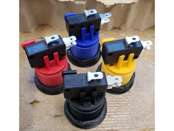 To attach a button, unscrew the nut, and place the button in the correct location.  Screw the nut onto the bottom of the button to fasten the button to the table