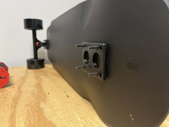 Flip the board over and place 4x truck bolts through the holes at the rear of the deck