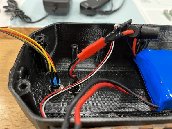 Connect the charge port to the battery by pushing the two red connectors together