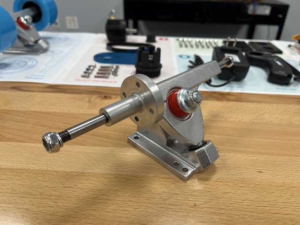 Place the silver washer back on top of the red bushing with the cupped side towards the bushing