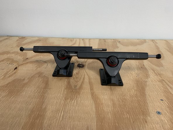 If your having trouble getting the locknut to start threading, make sure the hanger is pushed all the way into the base of the baseplate (where the hanger comes to a rounded point). You can also apply pressure down on the truck to compress the bushings