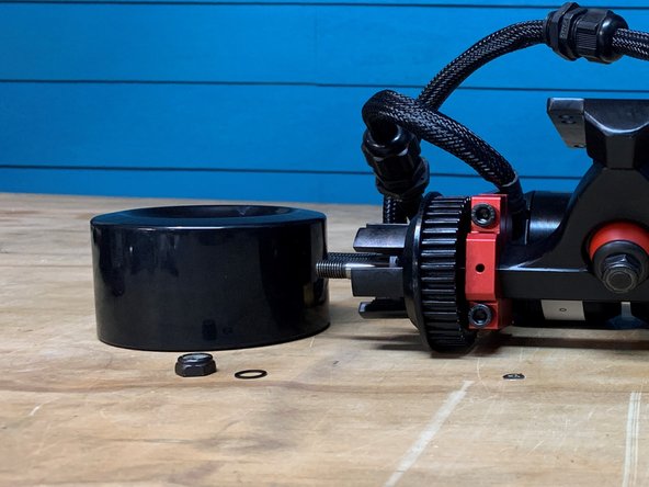 Remove the locknut, one washer, and wheel from the truck