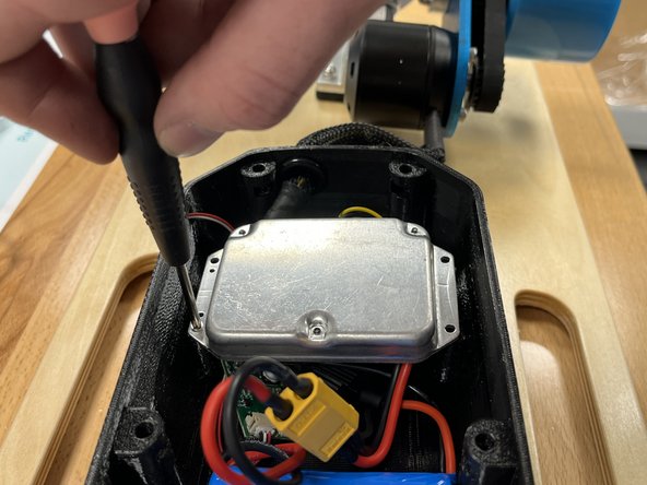 Use the 4x phillips screws and the screwdriver to secure the ESC to the enclosure