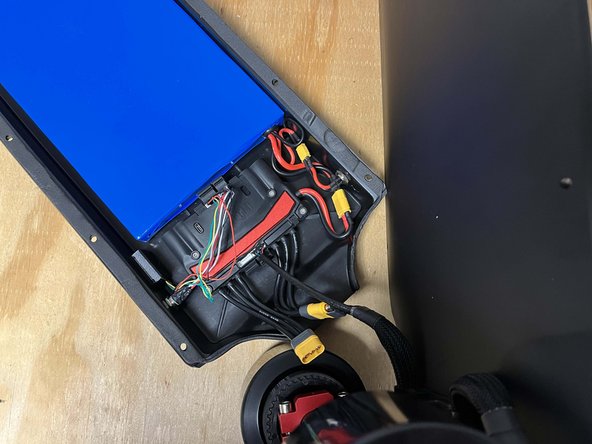 With the board on its side place the enclosure near the drivetrain to plug in the motors