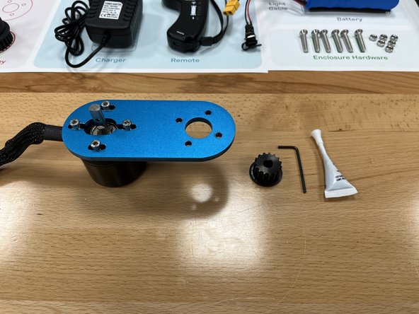 Gather the motor pulley from section 3 and the Loctite from the Tool Kit.