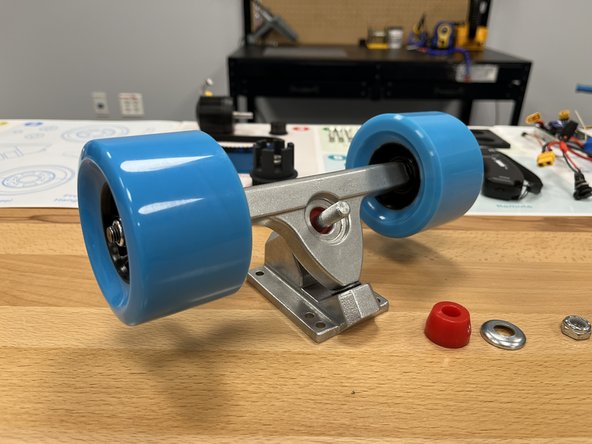 Place the hanger into the baseplate as shown. The top round part should fit inside the black pivot cup inside the baseplate.