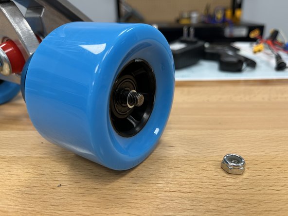 Place the silver spacer back onto the hanger