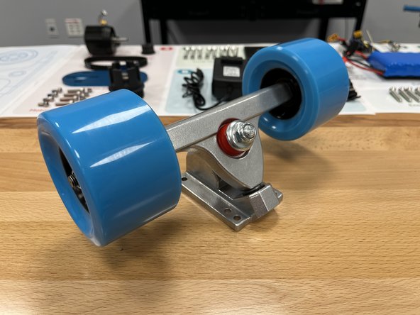 Place the silver washer back on top of the red bushing with the cupped side towards the bushing