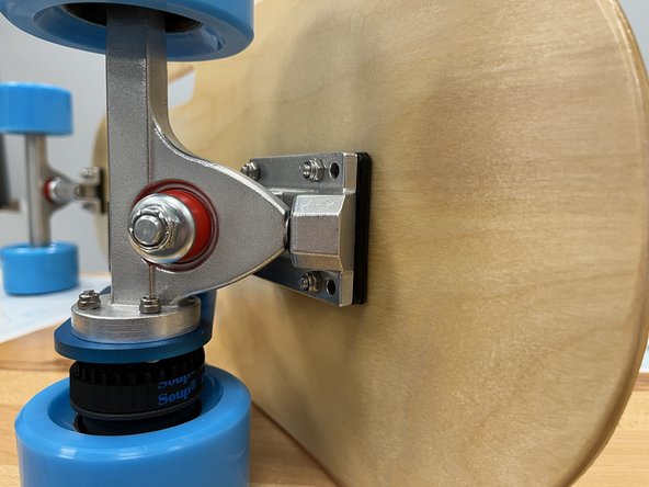 Secure the rear truck by adding the 4 locknuts to the bolts and tightening