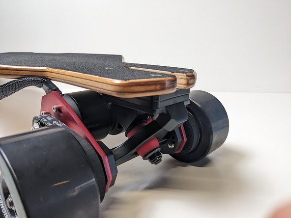 Add the truck with drivetrain with the motors underneath the deck, and the king pin facing the rear.