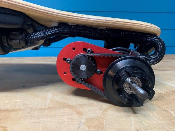 Secure the four screws while holding the motor in this position