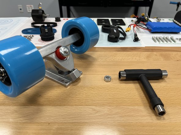 Place the red bushing back onto the truck with the smaller end toward the end of the bolt