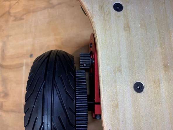 Move the motor mount back from the wheel so there is a gap, ensure that the wheel is as far back as possible