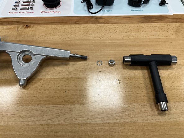 Remove the locknut and One (1) silver spacer from the other side of the hanger. One silver spacer should remain on the hanger.