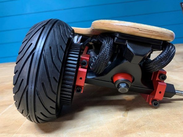 Tighten the two motor mount bolts half a turn at a time to evenly clamp the motor mount