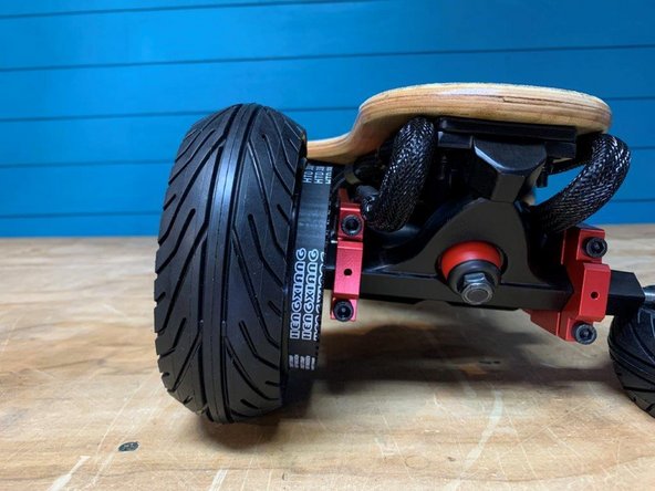 Reinstall the wheel with the belt around both pulleys