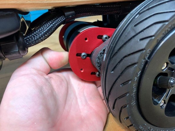 Pull back on the motor to tension the belt