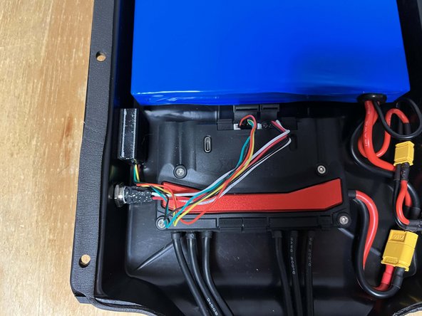 Peel the paper backing off of the Voyager receiver and place it in the enclosure as shown