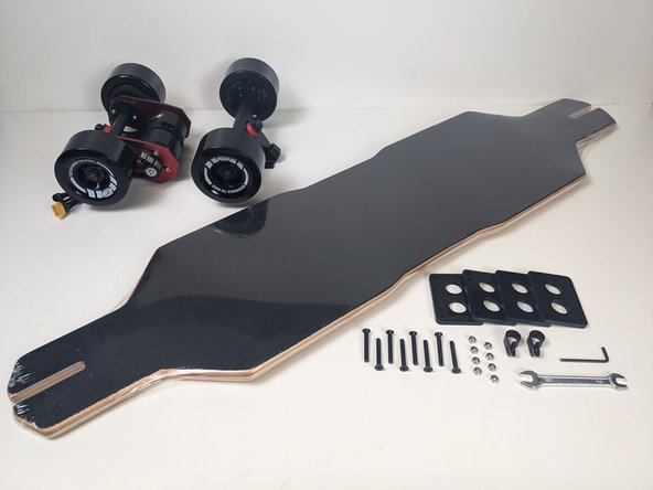 Gather the drivetrain, front truck, risers, truck hardware, wrench,  allen wrench, and deck.